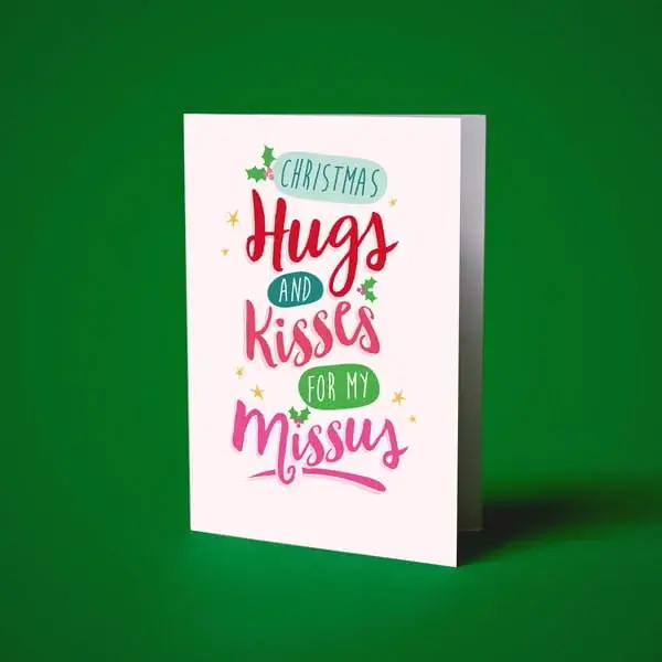Christmas greeting card with festive typography and holly accents displayed against a green background.